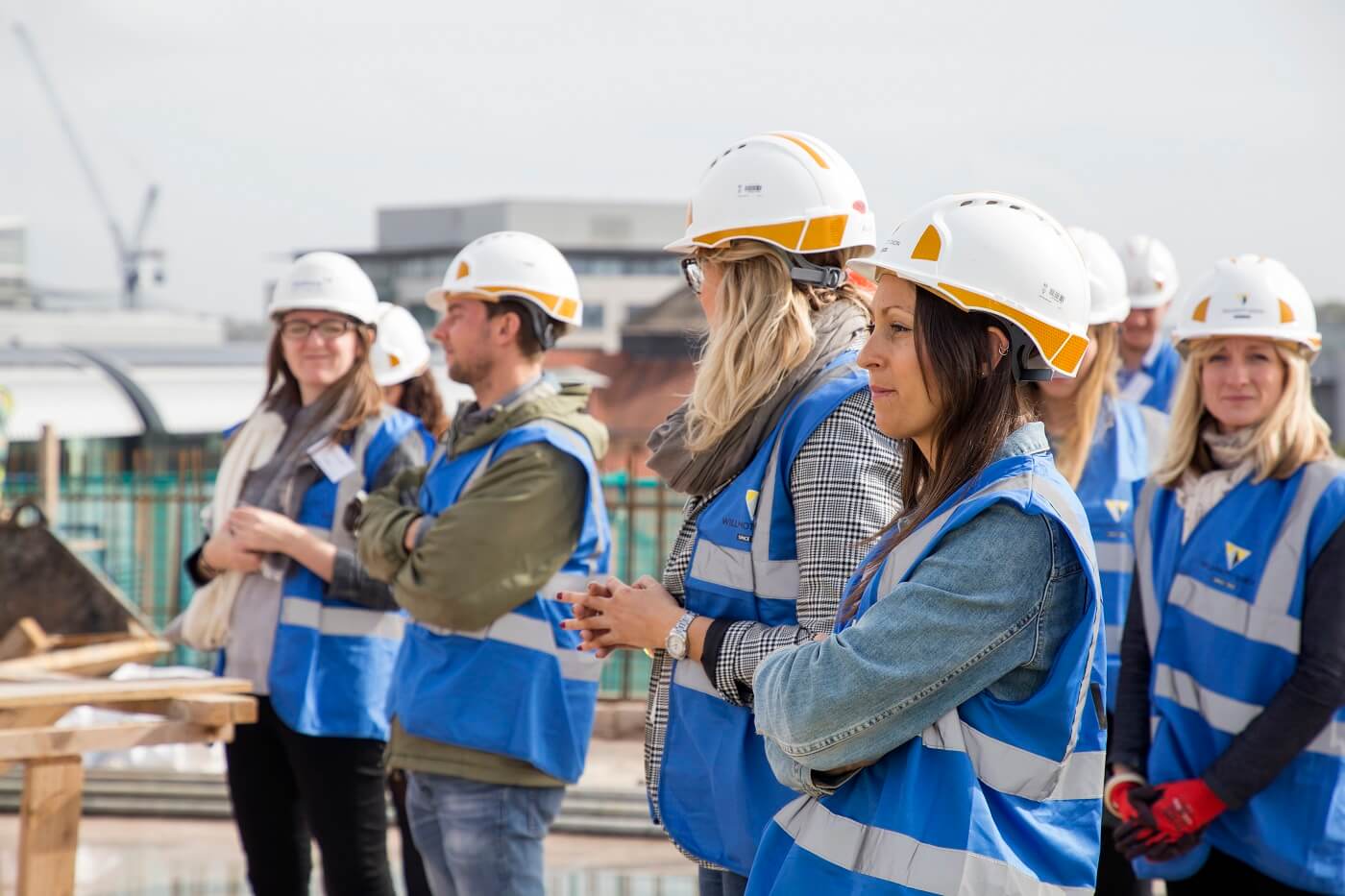 A group of young people viewing a construction site